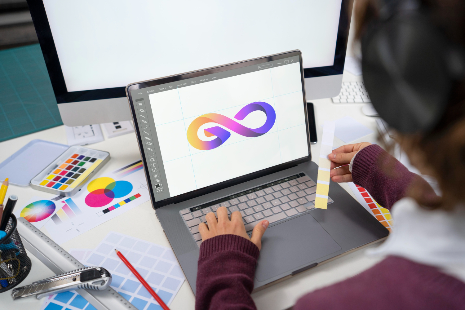 young female designer working on her laptop